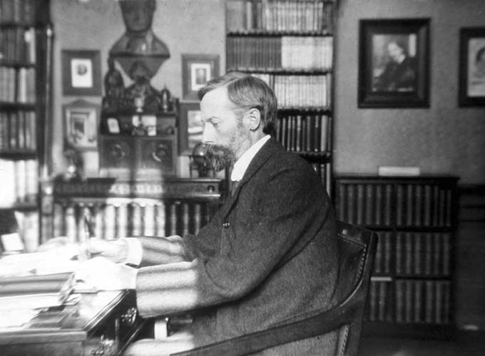Photo of John George Bartholomew at his desk